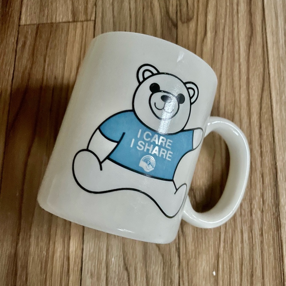 PFIZER White Ceramic Mug with Blue Bear Graphic "I CARE I SHARE"